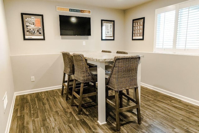 dining room with dark hardwood / wood-style flooring