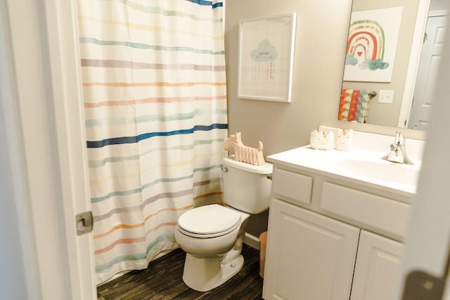 bathroom featuring hardwood / wood-style flooring, vanity, toilet, and a shower with curtain