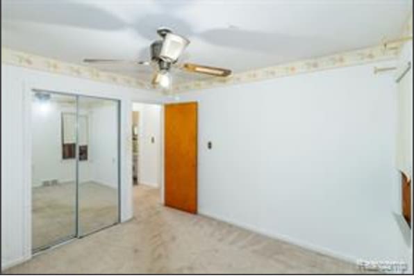 interior space with ceiling fan and light colored carpet