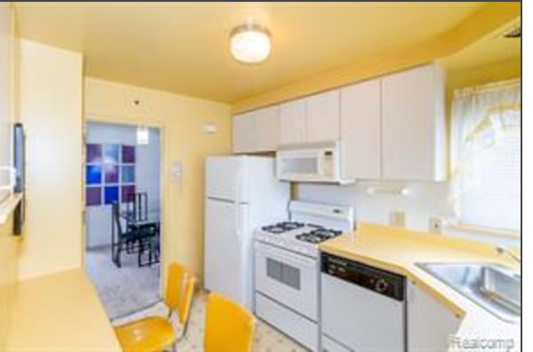 kitchen featuring white cabinetry, sink, and white appliances