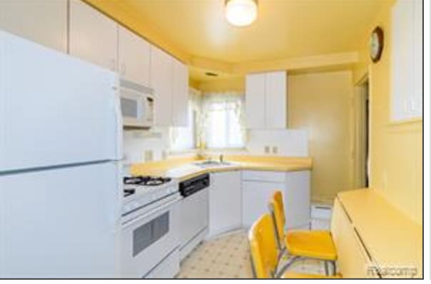 kitchen with white cabinetry, sink, and white appliances