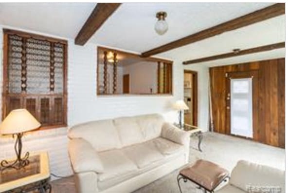 living room featuring beam ceiling