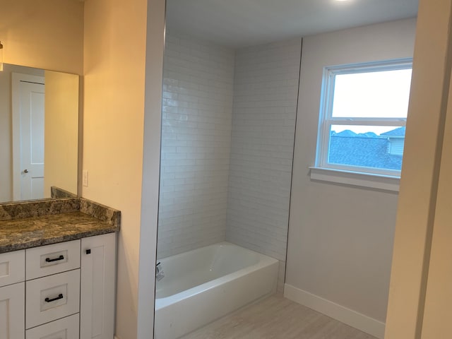 32627 Adam Brown Dr, Rockwood, MI 48173 - bathroom with vanity, wood finished floors, baseboards, and bathtub / shower combination