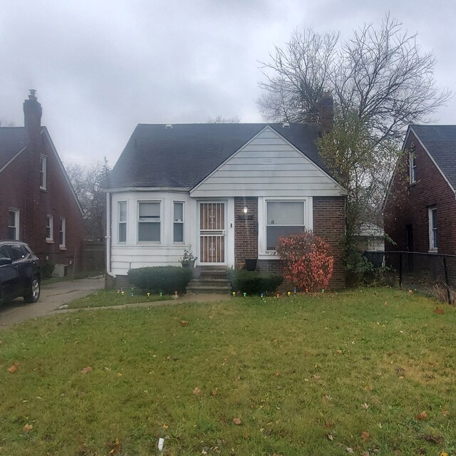 bungalow-style house featuring a front yard