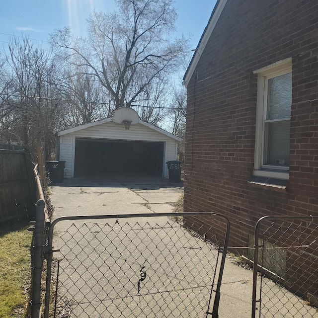 view of home's exterior featuring a garage, an outbuilding, brick siding, and fence