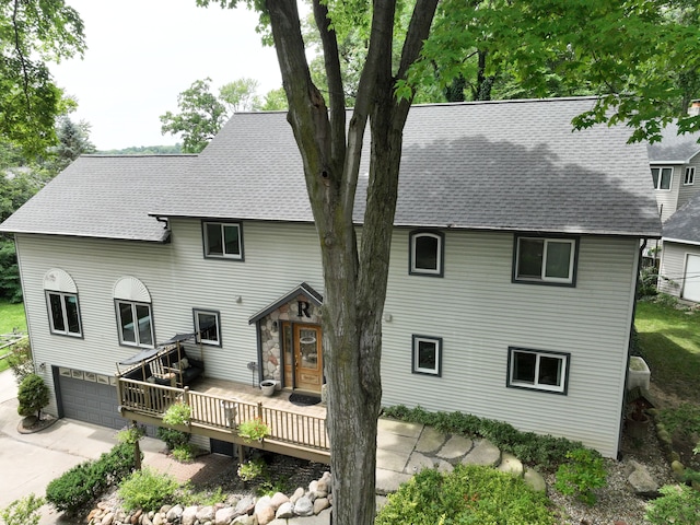 front facade featuring a garage and a deck