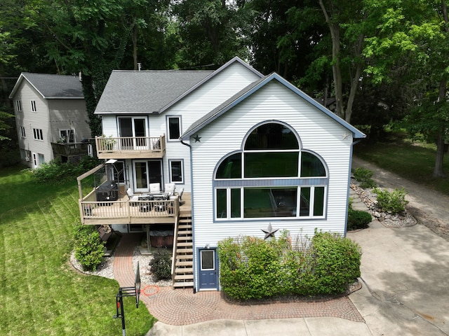 back of property with a yard and a deck