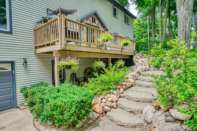 rear view of property featuring a deck