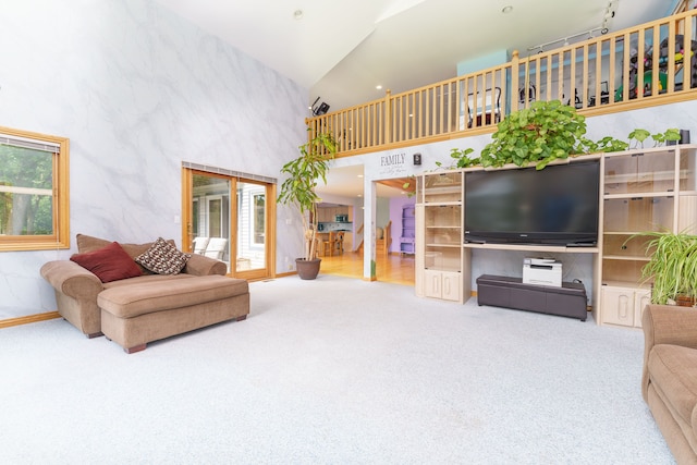 living room featuring carpet and high vaulted ceiling