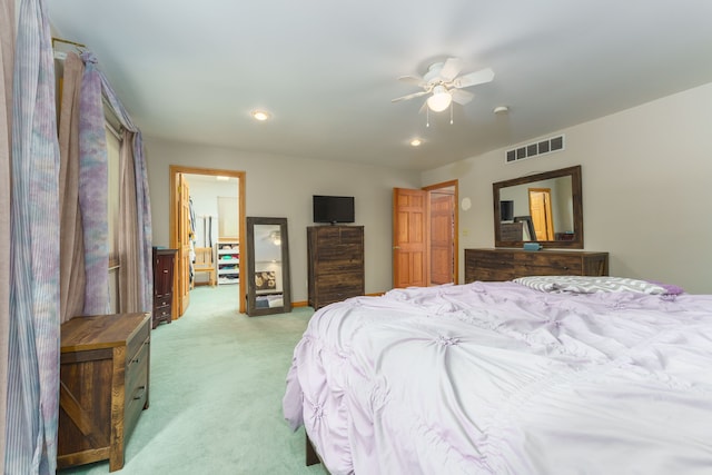 bedroom featuring light carpet and ceiling fan