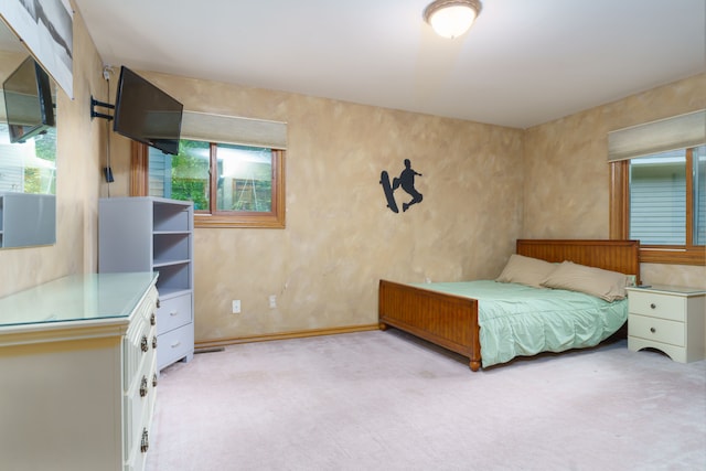 carpeted bedroom featuring multiple windows