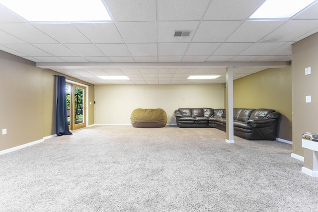 interior space featuring a paneled ceiling and carpet