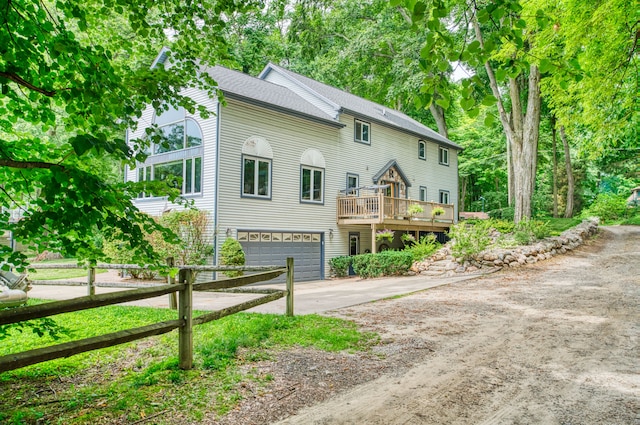 view of front of house featuring a garage and a wooden deck