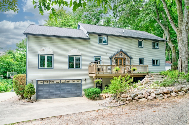 view of front of home with a garage and a deck