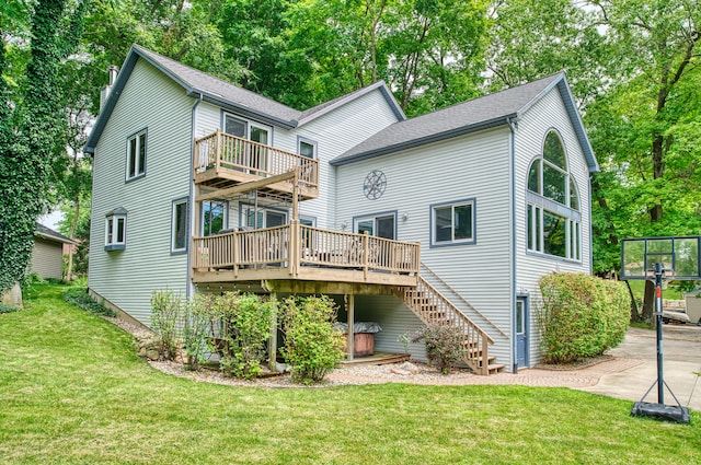 rear view of property featuring a lawn and a wooden deck