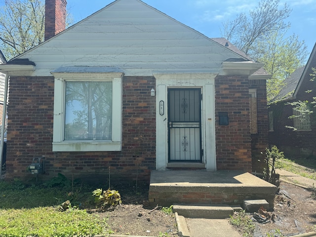 10420 Lakepointe St, Detroit, MI 48224 - view of front facade featuring brick siding and a chimney