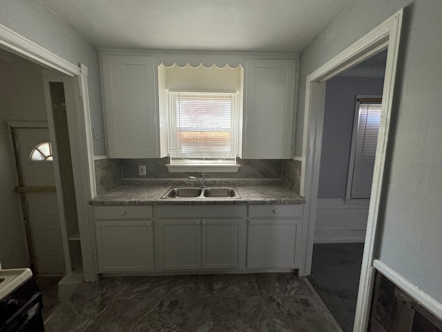 kitchen featuring white cabinets and sink