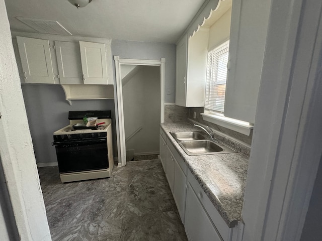 kitchen with white cabinetry, sink, and white appliances