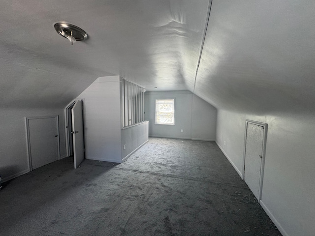 bonus room with carpet and vaulted ceiling