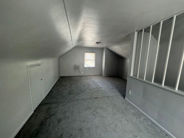 bonus room featuring light colored carpet and vaulted ceiling