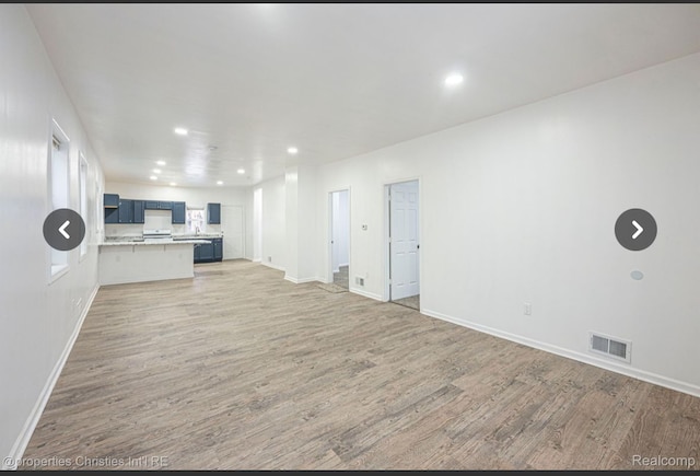 unfurnished living room featuring hardwood / wood-style flooring