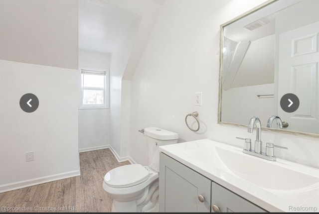 bathroom with vanity, hardwood / wood-style flooring, and toilet