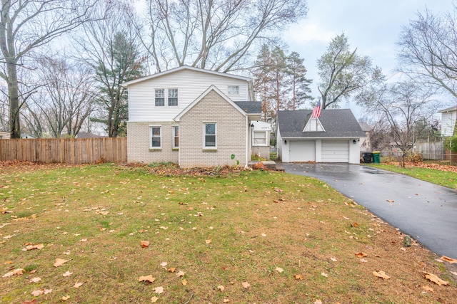 view of property with a garage and a front lawn