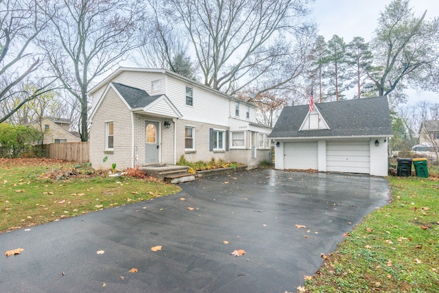 view of front of home with a garage and a front lawn