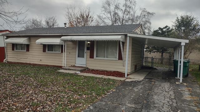 view of front facade with a front yard and a carport