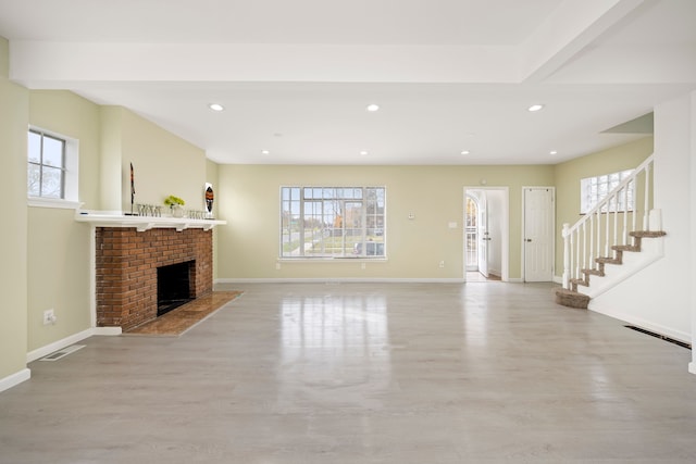 living room with plenty of natural light and a fireplace