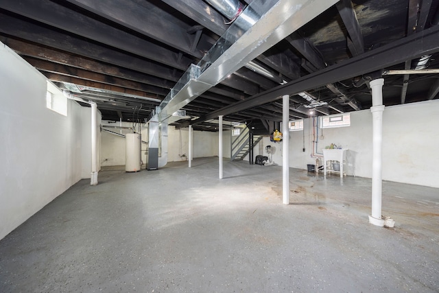 basement featuring gas water heater and heating unit