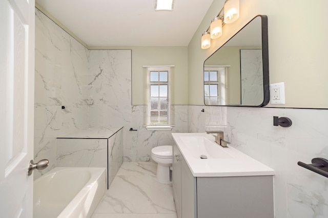 bathroom featuring vanity, toilet, tile walls, and a washtub