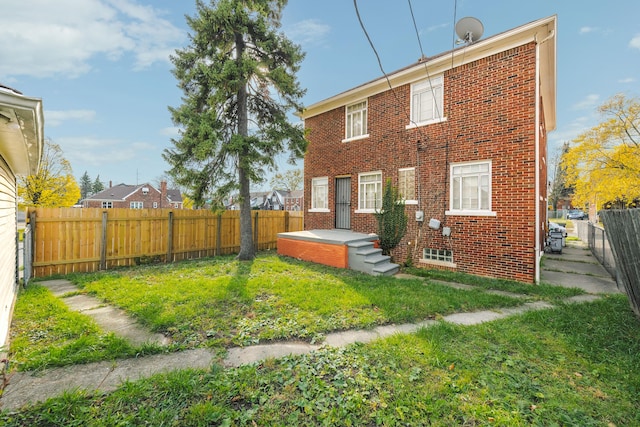 rear view of house with a yard