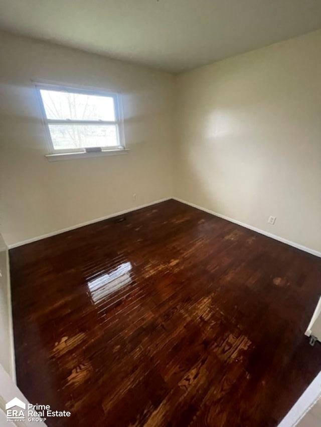 empty room featuring dark wood-type flooring