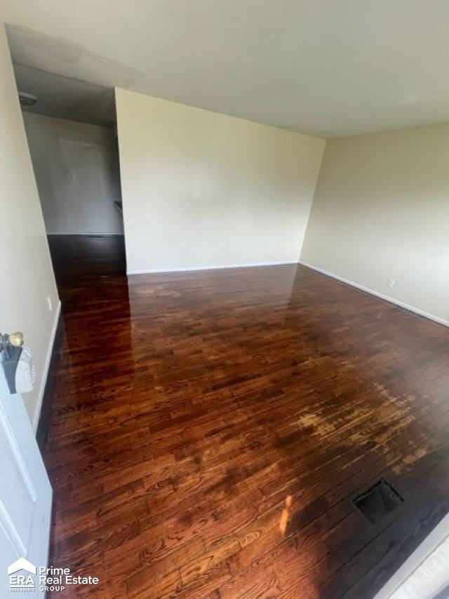 unfurnished room featuring dark hardwood / wood-style flooring