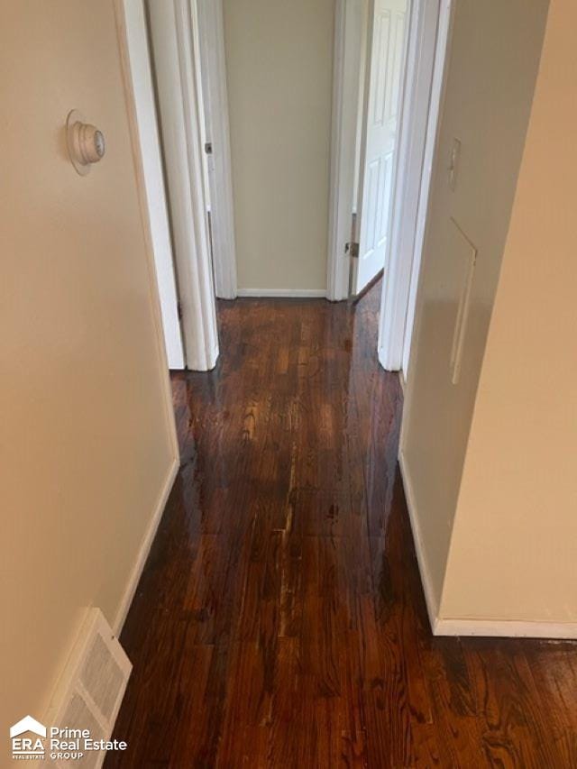 corridor with dark hardwood / wood-style flooring