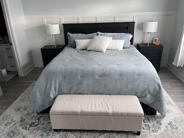 bedroom with dark wood-type flooring