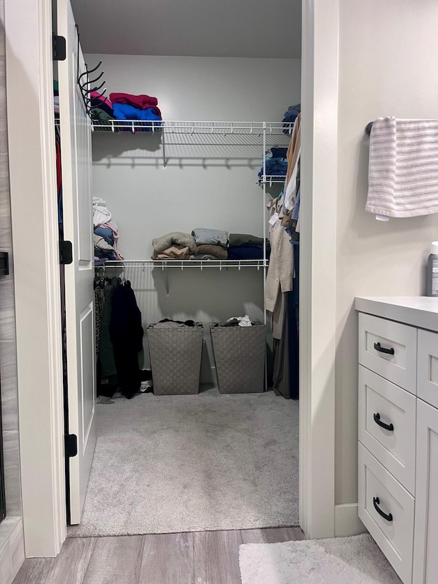 walk in closet featuring light hardwood / wood-style flooring