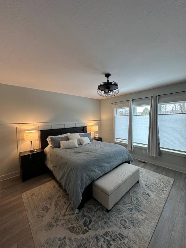 bedroom with dark hardwood / wood-style floors