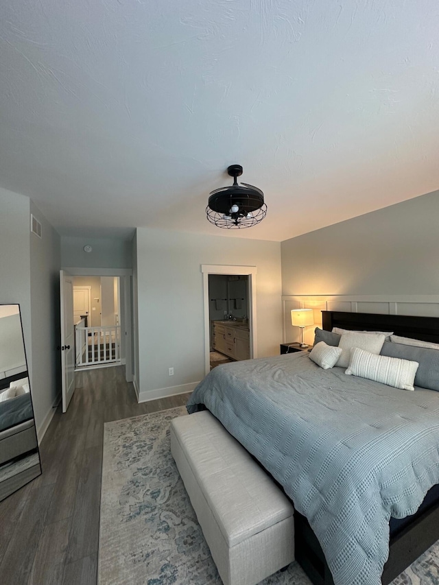 bedroom with dark hardwood / wood-style floors