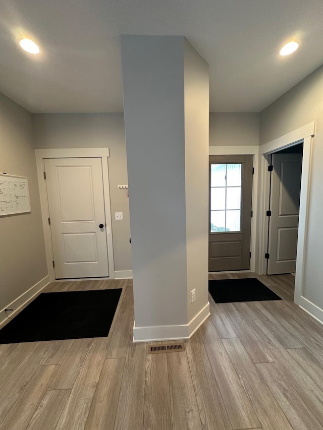 foyer entrance with light hardwood / wood-style floors