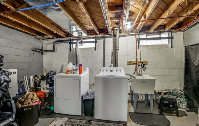 washroom featuring separate washer and dryer, sink, and a healthy amount of sunlight