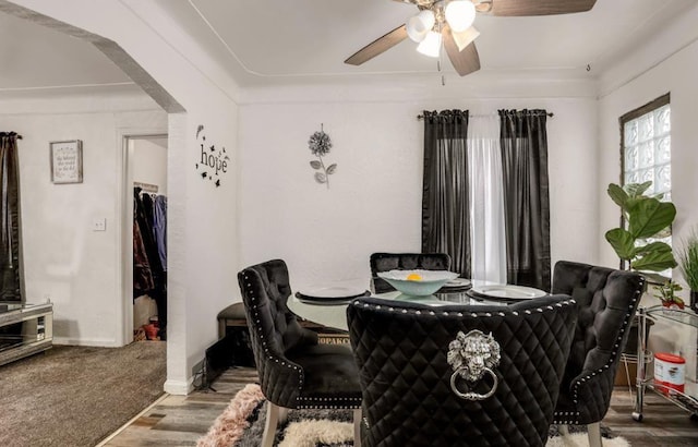 dining area with hardwood / wood-style flooring and ceiling fan