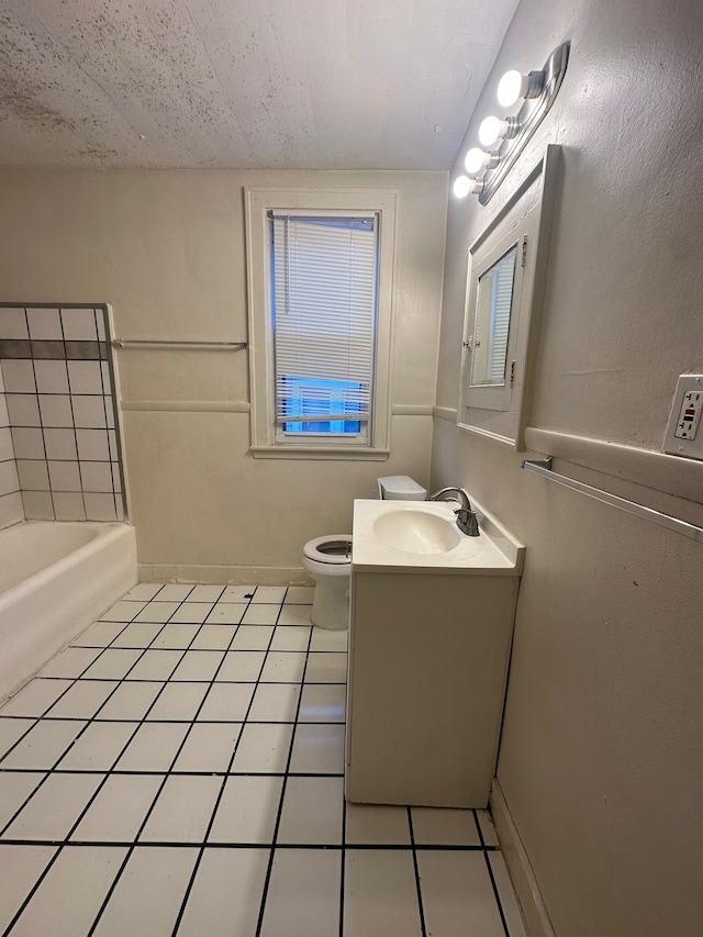 bathroom with toilet, a bath, tile patterned floors, and vanity