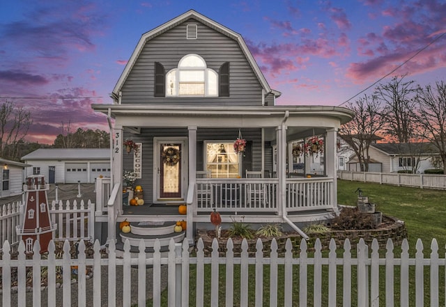 view of front of house featuring covered porch and a yard