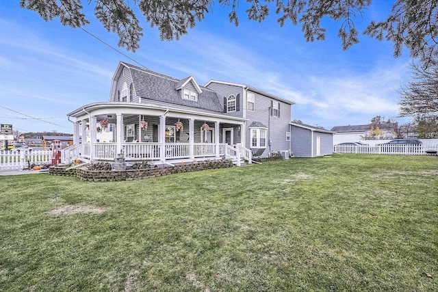 rear view of house featuring covered porch and a yard