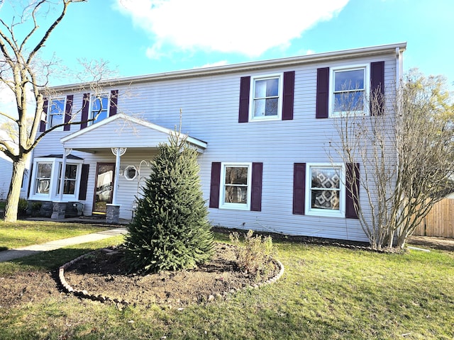 colonial home featuring a front yard