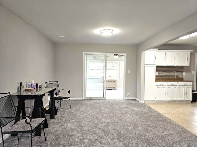 carpeted office with ceiling fan