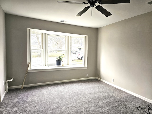 carpeted spare room featuring ceiling fan