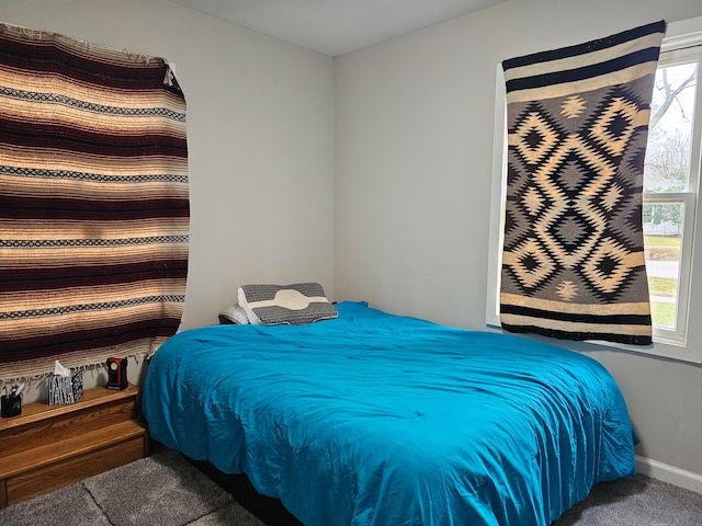 bedroom with carpet floors and multiple windows